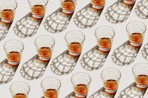 Glasses with strong drink as minimal geometric pattern, beautiful shadow at sunlight on beige textured background, aesthetic photo shiny glass, sun glare, alcohol drinks concept, summer