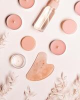 Guashe scrapes from rose quartz and moisturizing gel Natural stone massager for face, photo