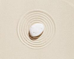 Zen garden meditation sandy background White stone and lines on sand texture photo