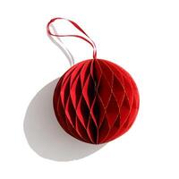 Close up Red Christmas paper ball isolated on white background, Scandinavian Christmas honeycomb ornaments. New year paper bauble, Modern xmas decoration, minimal style winter holiday, above photo