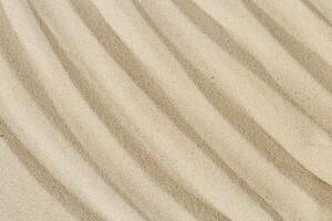 Lines drawing on sand, beautiful sandy texture. Spa background, concept for meditation and relaxation photo