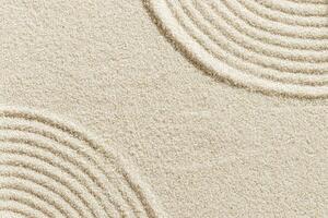 Top view pattern in Japanese Zen Garden with close up concentric circles on sand for meditation and relaxation. Aesthetic minimal sandy background with copy space, beige monochrome neutral color photo