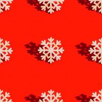 Christmas seamless pattern with wooden snowflakes on red. New Year holiday concept. photo