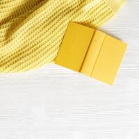 Concept digital detox, offline home activities as reading book. Top view with book in yellow cover photo