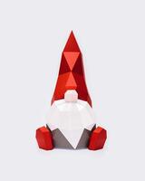 Volumetric paper Christmas gnome in red pointed hat on light , polygonal figure dwarf photo