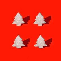 Christmas greeting card with wooden decoration are Christmas tree with dark shadow on red background. photo