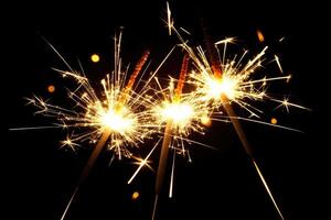 Sparkler fireworks glowing brightly in the dark, creating a festive and celebratory atmosphere photo