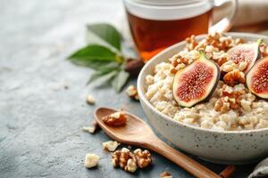Delicious breakfast bowl with oatmeal, figs, walnuts, and herbal tea in a calm rustic setting photo