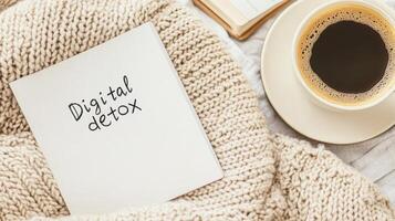 A cozy bed with a digital detox note, blanket, book, and coffee promotes relaxation photo