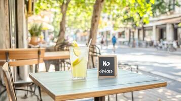 Sitting at an outdoor cafe table, sipping lemonade and enjoying snacks while embracing a device-free environment photo