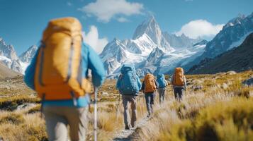 Hikers trek along a mountain trail surrounded by stunning alpine scenery under bright blue skies photo