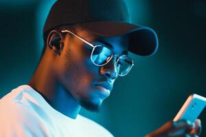 Person interacts with a mobile device, face illuminated by a calming blue light in a dark environment photo