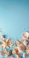 Various seashells and sand on a blue background photo