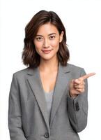 Professional asian woman pointing confidently clean white background studio portrait photo