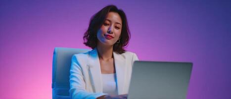 Focused businesswoman working on laptop vibrant office setting digital content professional environment photo