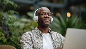 Eager black man discovering new content on laptop in cozy indoor environment photo