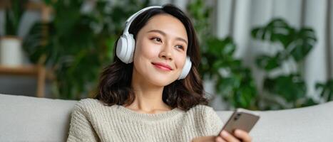 Young asian woman relaxing on plush sofa home lifestyle image bright environment photo