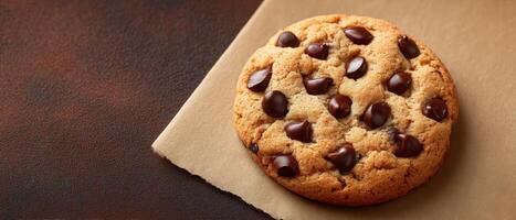Soft chocolate chip cookie on parchment paper delicious treat home baking warm close-up photo