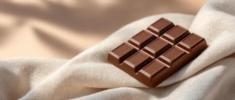 Dark chocolate bar display on soft fabric minimalist aesthetic neutral tones photo