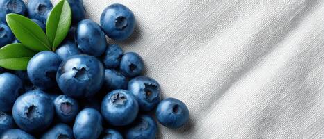 Vibrant blueberries flat lay on white linen food photography bright natural light aesthetic view photo