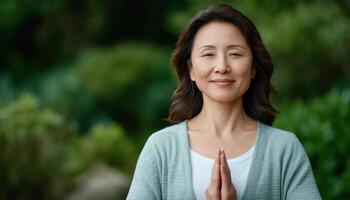 Asian woman practicing tai chi in serene park focused on balance and wellness photo