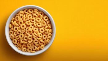 Minimalist top view of dry cereal on sunny yellow surface in low resolution photo
