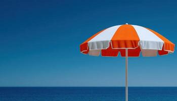 Vibrant orange beach umbrella against deep blue horizon coastal relaxation scene minimalist view photo