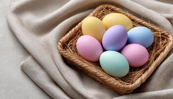 Colorful pastel easter eggs in tray on soft fabric spring decor light and airy setting photo