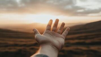 Reaching for the sun a hand to the sky at sunset nature scene inspirational viewpoint photo