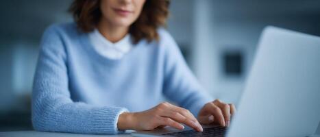 Focused typing on laptop in minimalist workspace modern office digital content creation photo