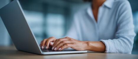 Focused hands typing on laptop in minimalist workspace digital content creation professional environment photo