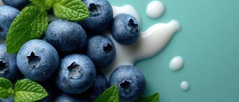 Scattered blueberries and milk droplets on pastel green background food photography fresh ingredients photo