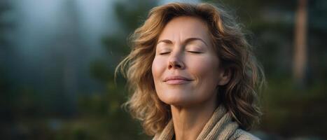 Woman breathing deeply in forest morning mist nature scene tranquil environment photo