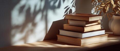Warm sunlit books stacked neatly on shelf in cozy reading nook photo
