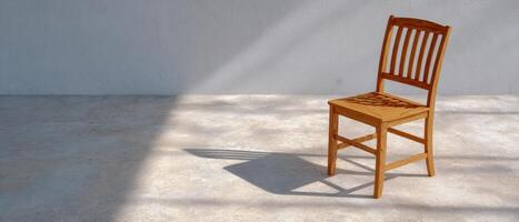 Chair and shadow on smooth concrete floor at noon minimalist design modern space photo