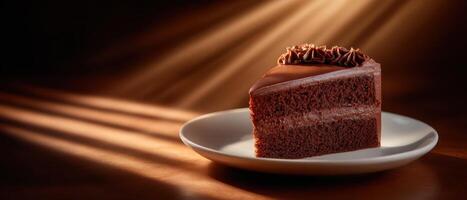 Moody chocolate cake slice in strong directional light indoor setting food photography photo