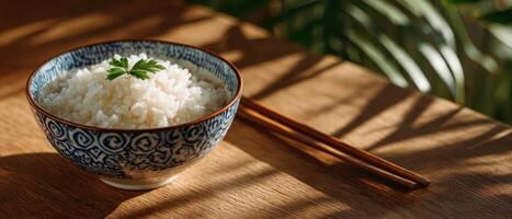 Sunlit bowl of rice with chopsticks on kitchen counter warm home environment photo