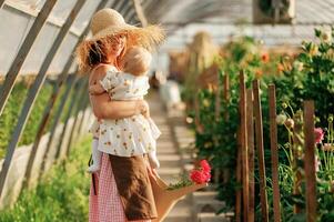 Little cute baby. Mother, and ,daughter are in the greenhouse photo