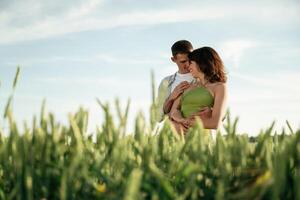 Standing,and enjoying nature and each ,,other. Lovely couple are on the agricultural field together photo