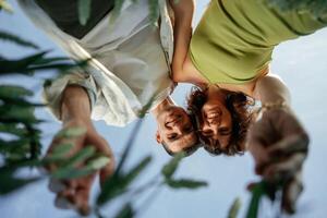 View from below of, couple that is standing in the agricultural field photo