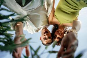 View from ,below of couple that is standing in the agricultural field photo