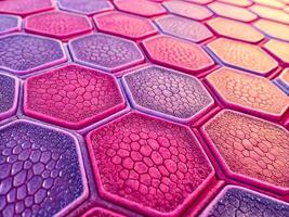 Patterned surface with hexagonal cells shapes in pink and purple tones photo