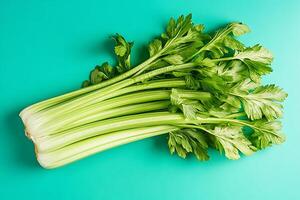 Crisp celery bunch on turquoise background photo