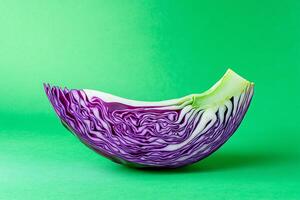Red cabbage slice on green backdrop photo