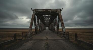 Distant horizons over weathered bridge on cloudy desolate landscape photo