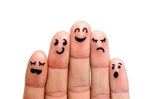 A collection of fingers expressing different human emotions through simple and artistic hand drawn facial expressions on a white background. photo