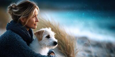 Woman enjoys quiet moment by the sea with her dog during a tranquil evening at the beach photo