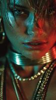 Close-up portrait of an intense model with shimmering skin and layered jewelry under dramatic lighting photo
