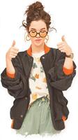 Joyful young woman giving thumbs up while dressed in casual spring attire, showcasing confidence and style photo