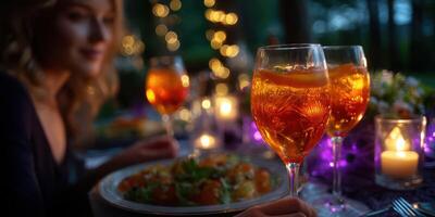 Enjoying a vibrant outdoor dinner party with sparkling drinks and twinkling lights at twilight photo